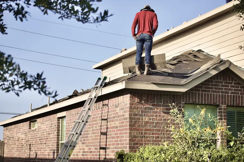 Professional roofer working on a residential roof in Larisons Corners